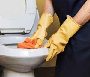 Cleaning a restroom during a closing checklist